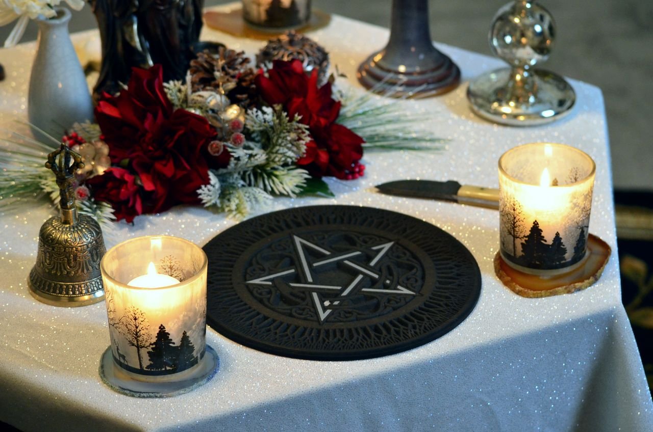 A beautifully decorated pagan altar with candlelight and a pentacle centerpiece, perfect for rituals.